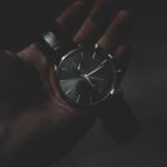 person holding watch pointing at 6:17