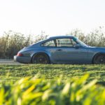 blue Porsche 911 parked beside road